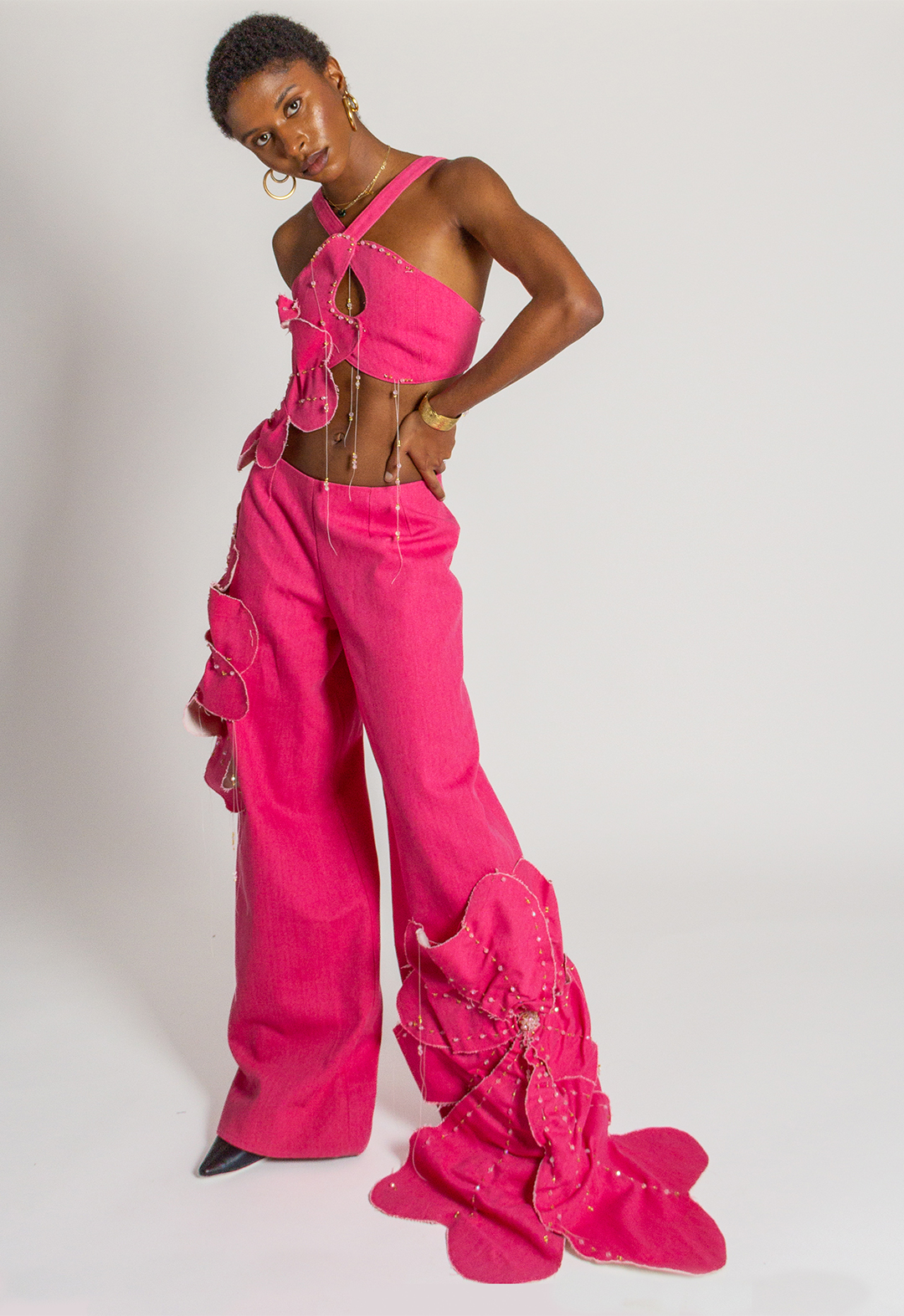 Pink beaded floral denim top paired with pink denim pants, with ruched beaded flower appliqués.