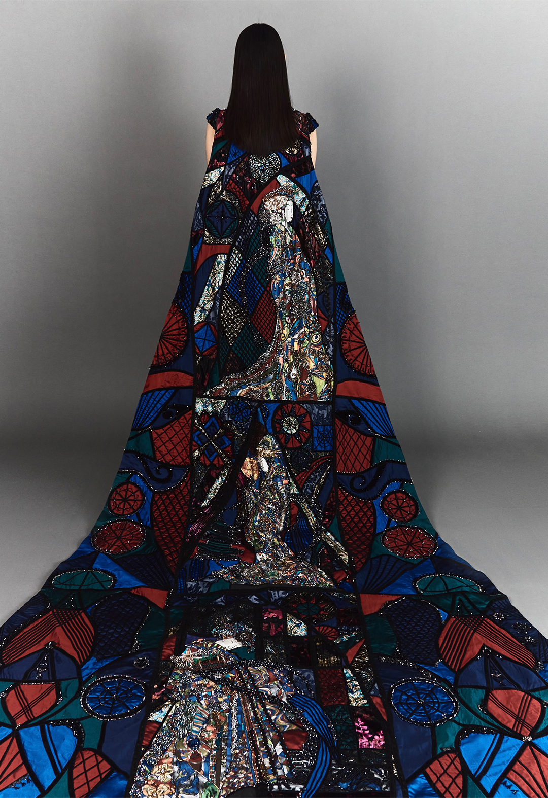 A back view of a model wearing a stained glass cape.
