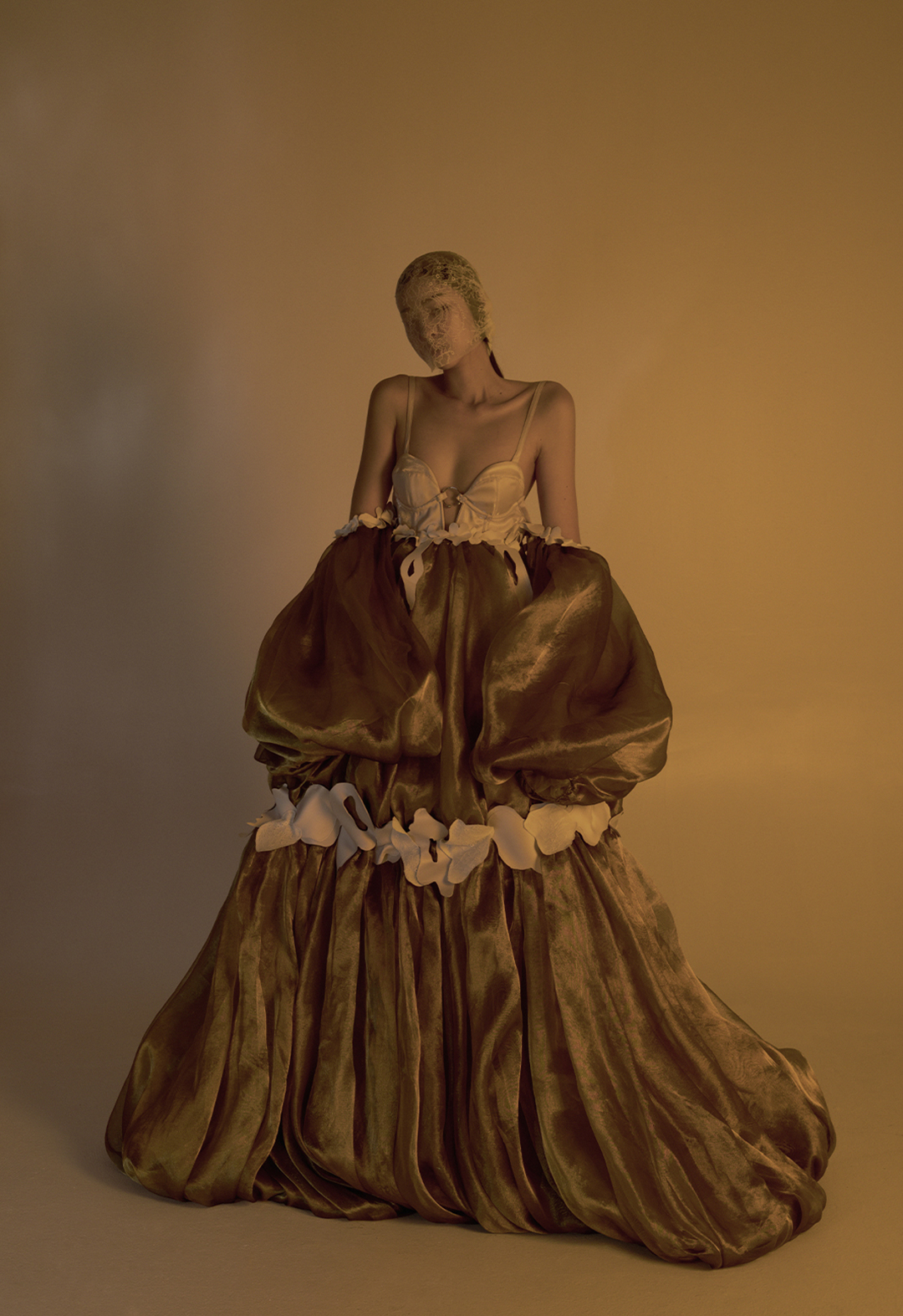 The model faces the camera in this photo. The two off-shoulder bubble sleeves are at her sides, reinforcing the comprehensive bubble shape of the gown.