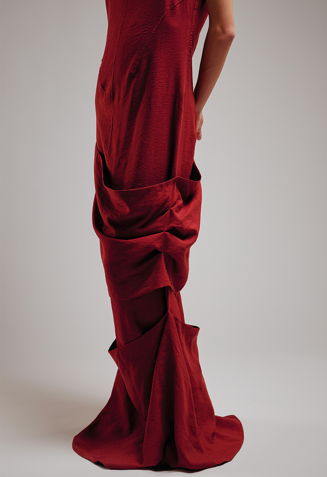 The drapes were created by hand tucking each layer to the dress, creating depth and showing the inside lining.