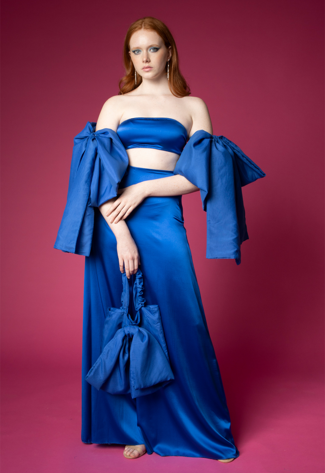 A model is wearing a royal blue charmeuse bandeau, with matching cotton voile bows and palazzo pants.