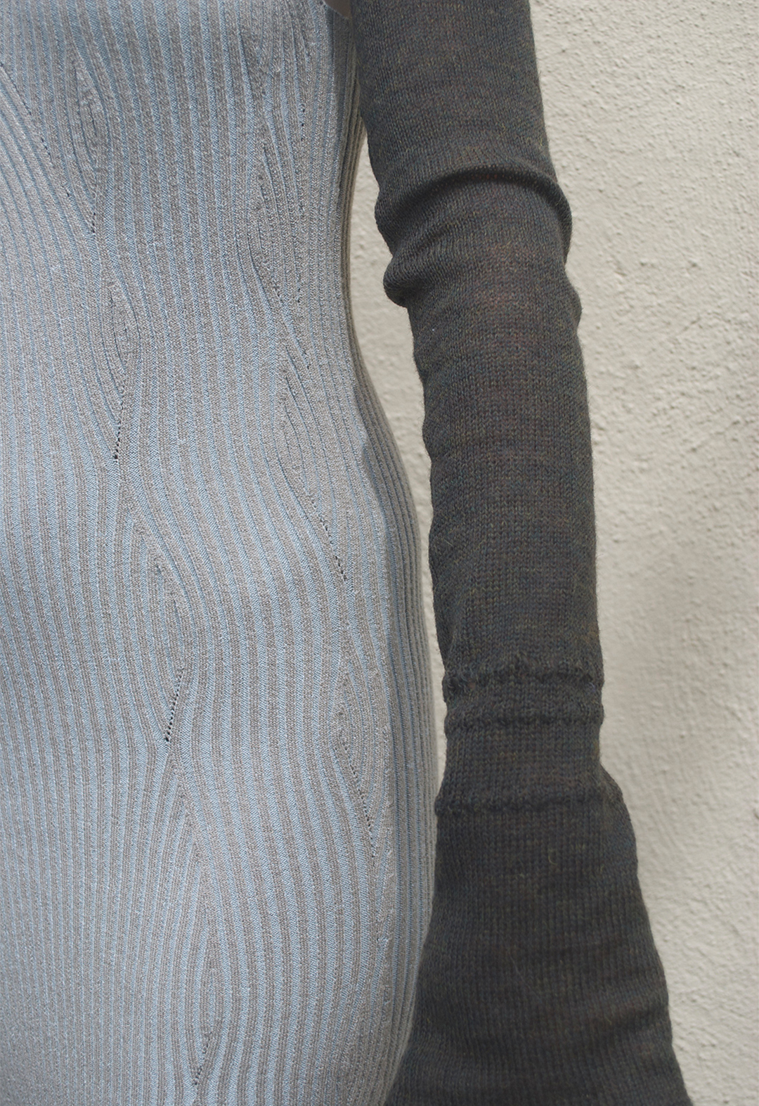 The photo shows a close-up detail shot of the shrug sleeve.