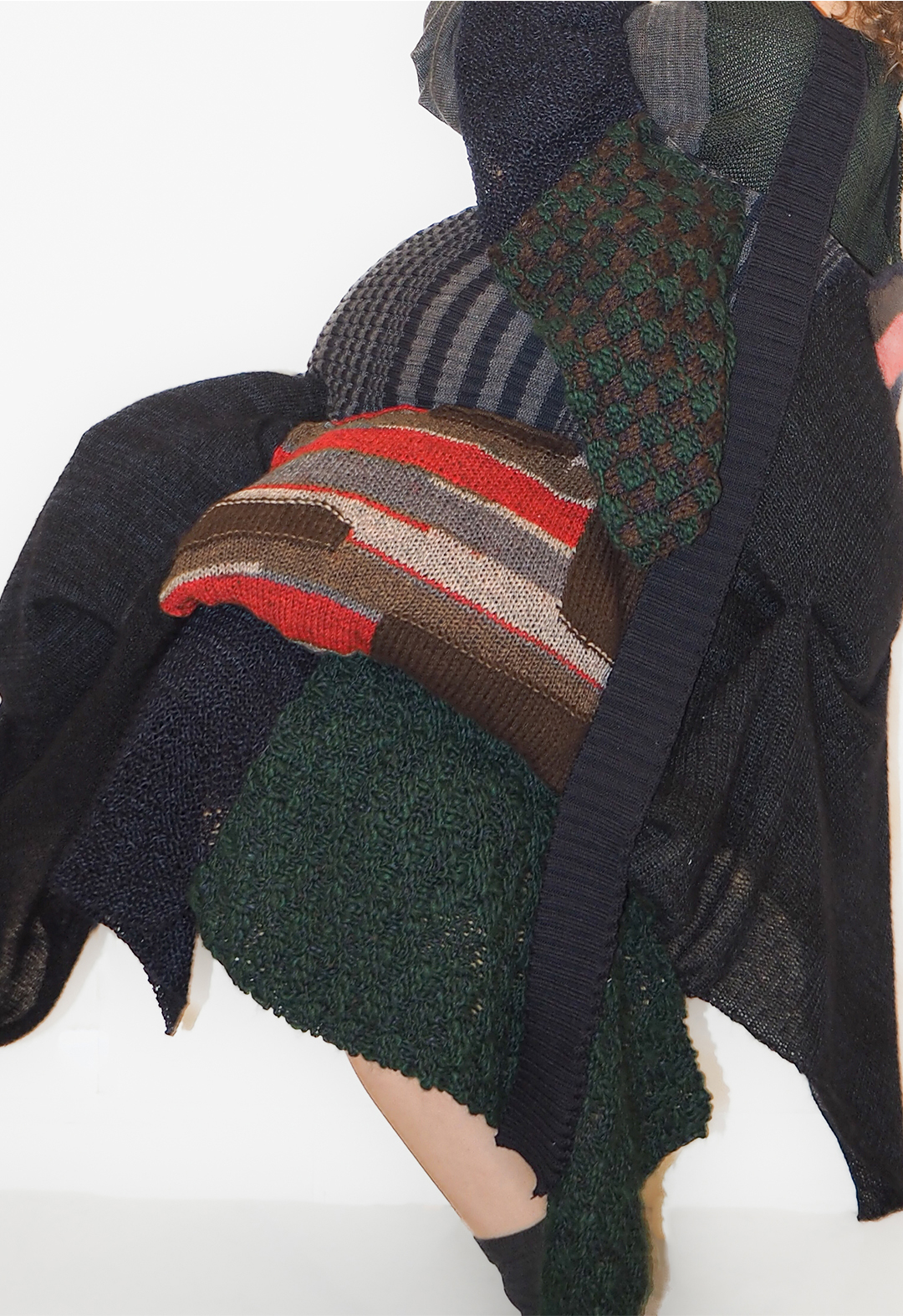 The photo shows a detail view of various fabrics and distorted shapes of a patchwork dress