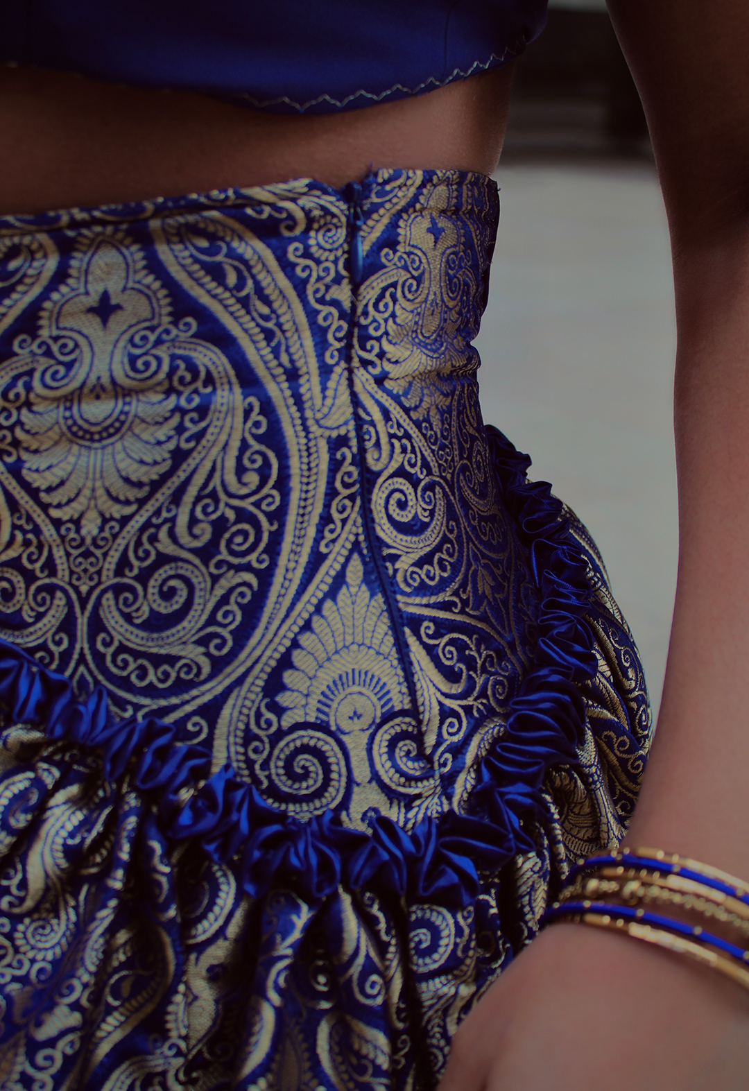 This close up shot of the waist of the skirt shows the contrast binding between the waist yoke and the gather skirt, giving the skirt more dimension. The pattern of the brocade is also more defined, allowing the richness and elegance of the fabric to shine through.