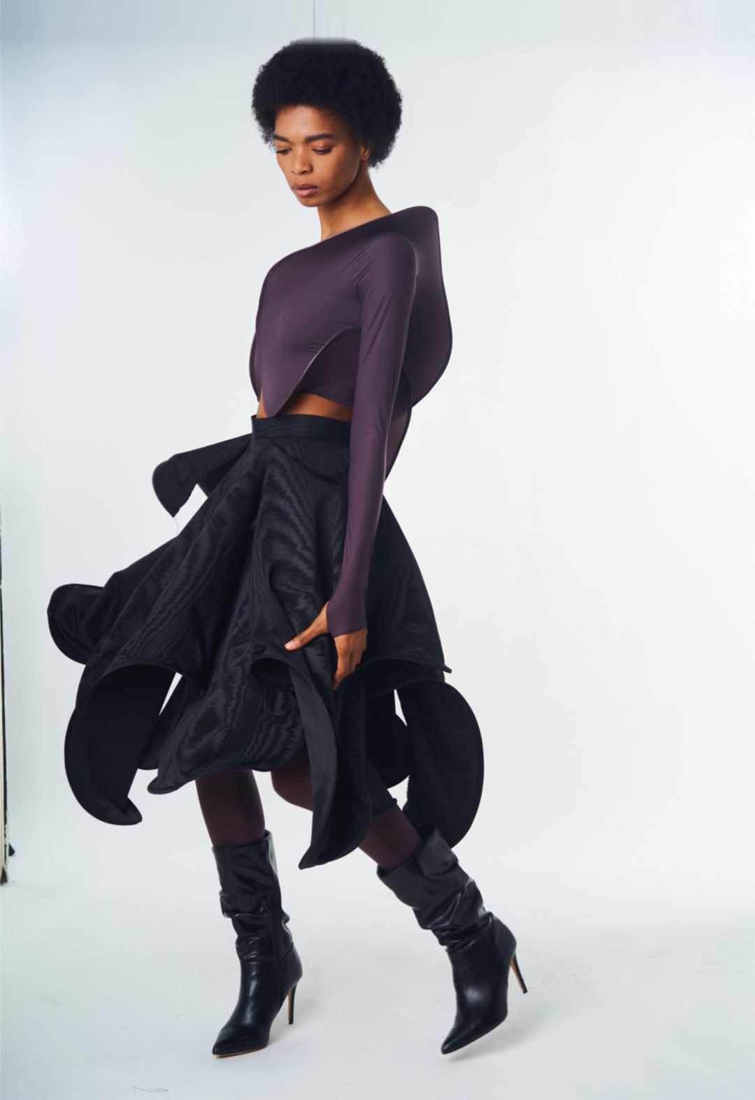 A model presents the top and skirt in a three-quarter view.