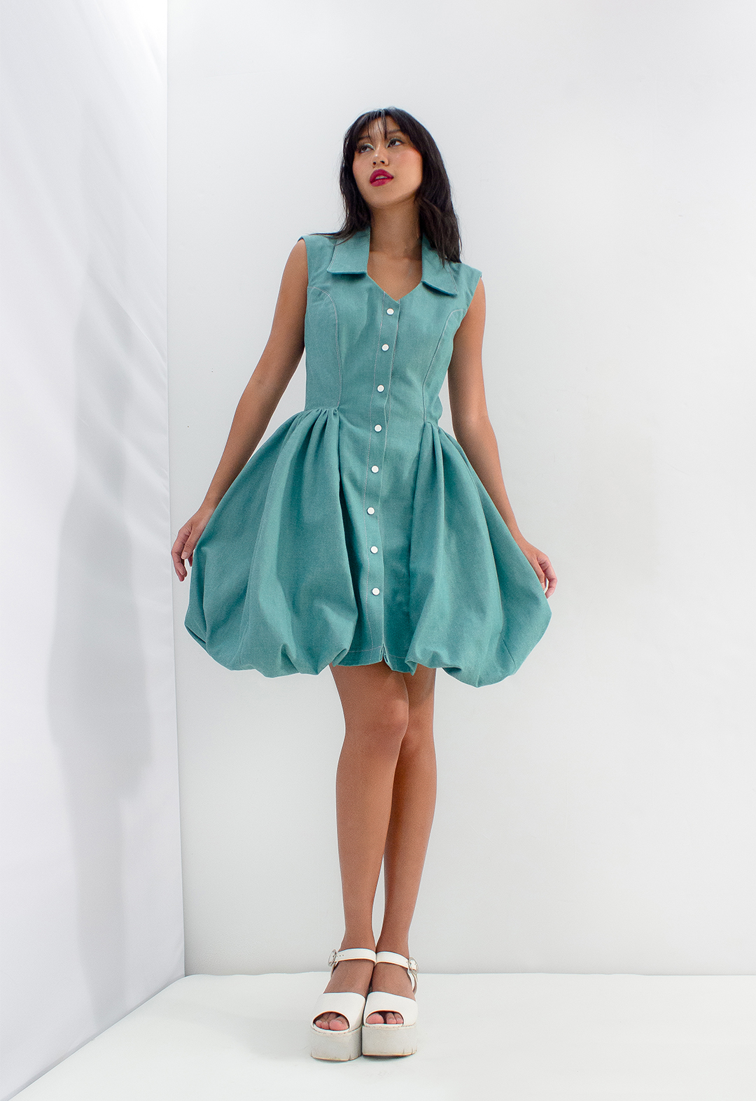 This look is inspired by the volume of petals seen on blooming flowers. During full bloom, a lot of flowers open their petals beautifully, and this look is to tell the story of a flower fairy flying through a botanical garden in the blooming moments. The entire dress is designed with teal denim to echo the pants’ look, with a fitted princess line and bubbles at the sides. The bubbles are the imaginary petals that create the shape of a flower. The idea of the dress is to give a whimsical scene of being in any flower garden that the audience can imagine.