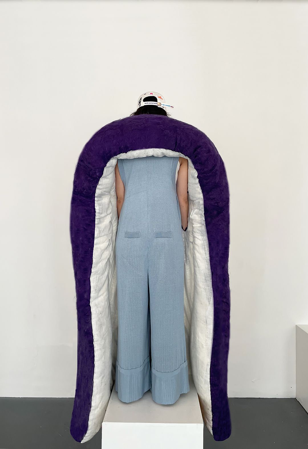 The garment, inspired by the back structure of a sofa or mattress, creates a forever bed for the dead.