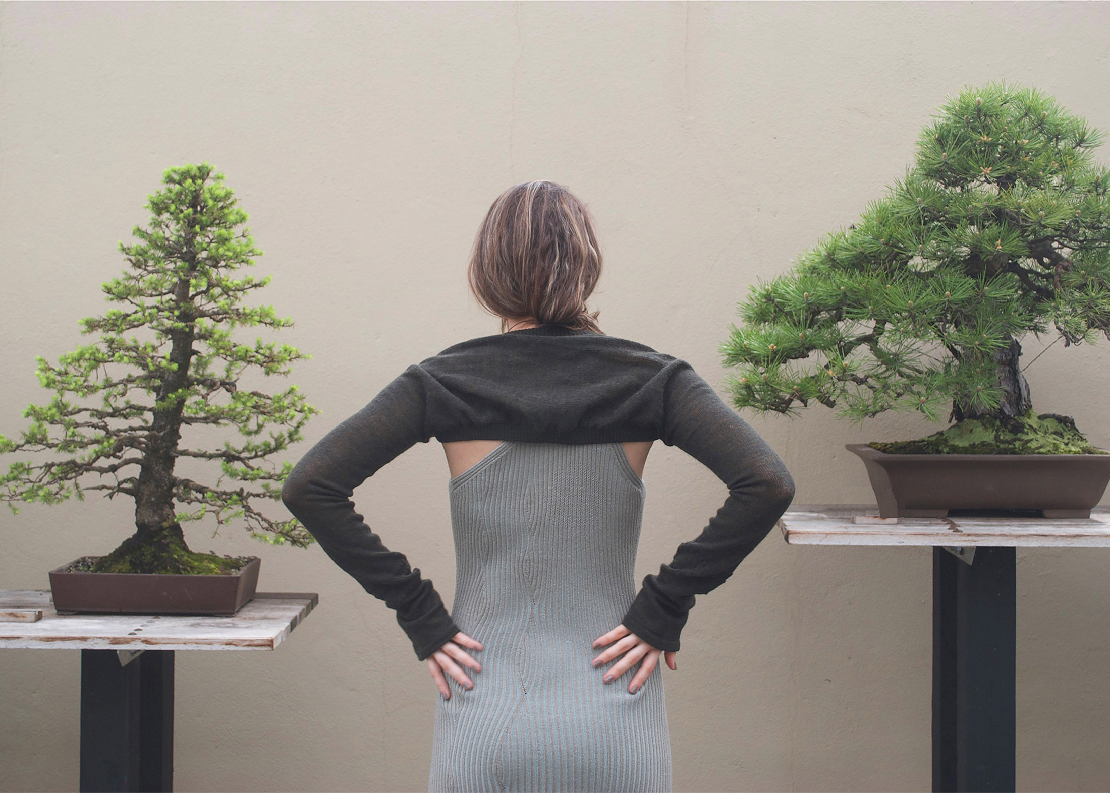 Back view of the look, showing the shrug knitted in one piece.