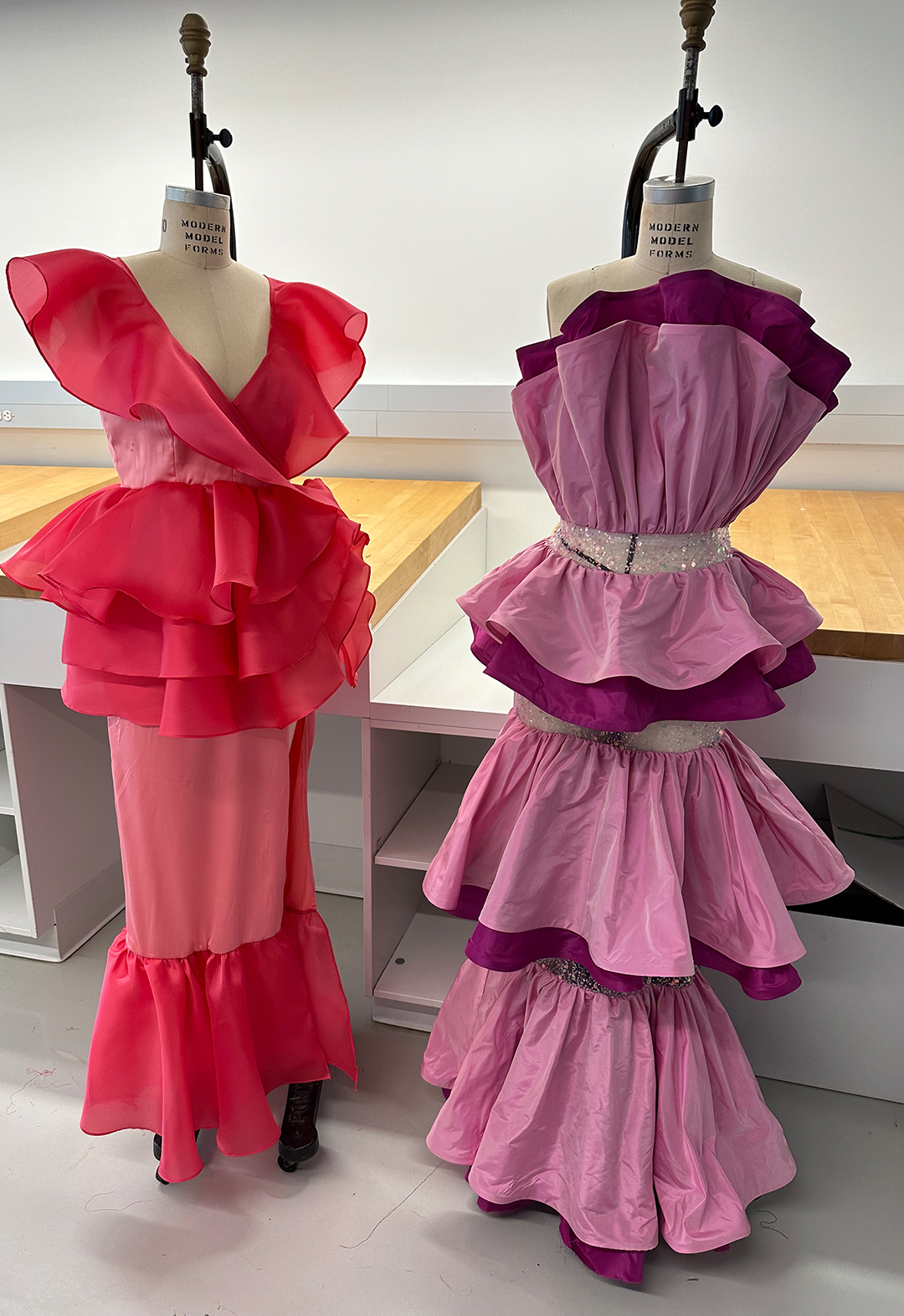Salmon and peach layered ruffled dress and a 3 tiered double pink + purple ruffled dress with crumbcatcher bodice & beaded skirt.