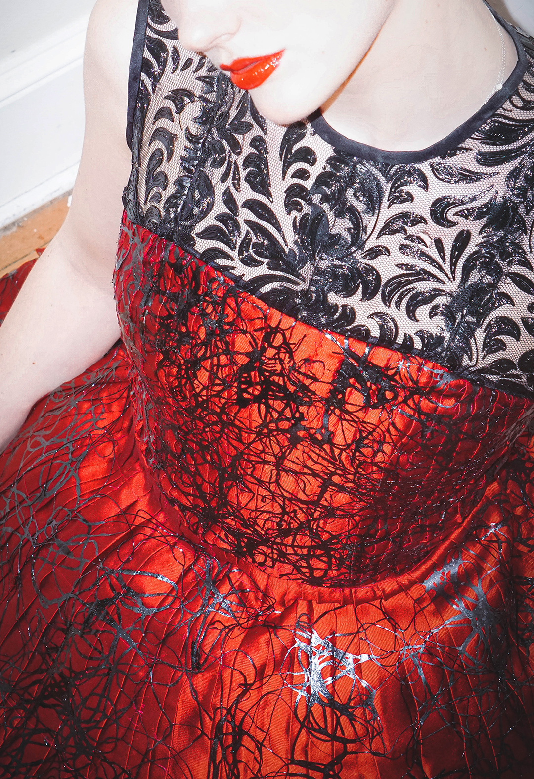 Extreme close-up photo shows the 3D-printed lace mesh at the neckline of the garment.